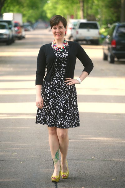 black fitted cardigan with leopard printed elongated knee length dress