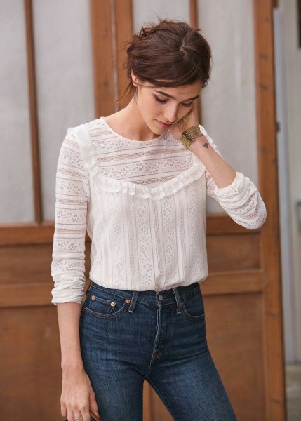 white patterned blouse with blue high-waisted slim jeans