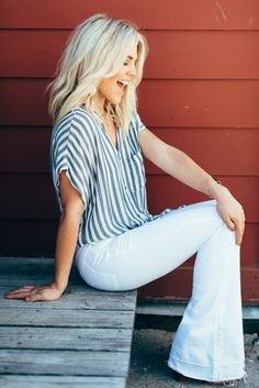 gray and white striped short sleeve button up shirt with bell bottom jeans