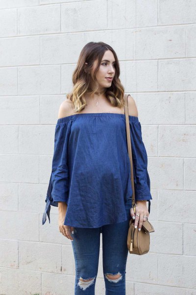 blue chambray of the blouse with ripped maternity jeans