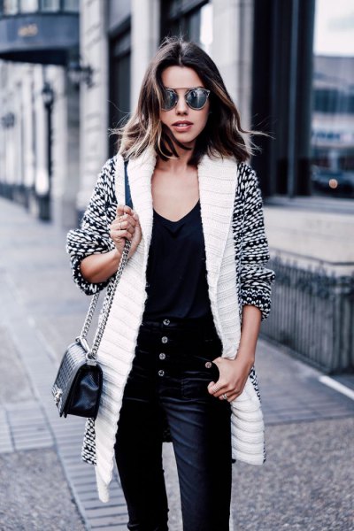 white and black printed long line sweater cardigan with velvet trousers