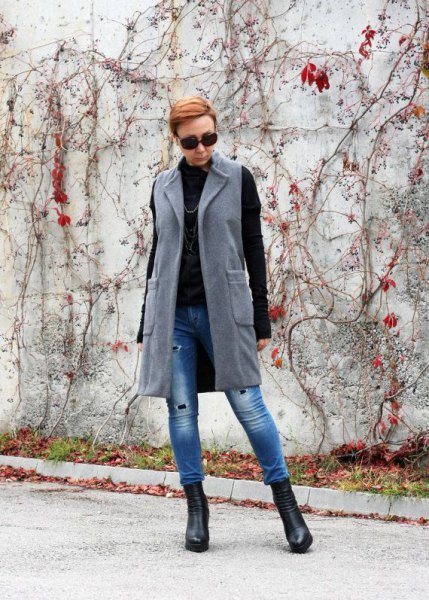 gray long-line wool vest with blue skinny jeans and black sweater