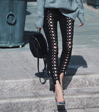 gray chunky knit sweater with black lace trousers