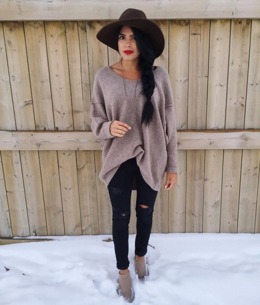 black floppy hat with gray big sweater and ripped black jeans