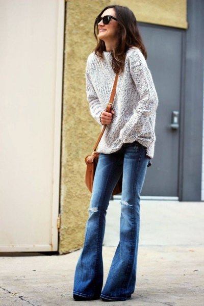 Heather gray sweater with blue ripped blown jeans