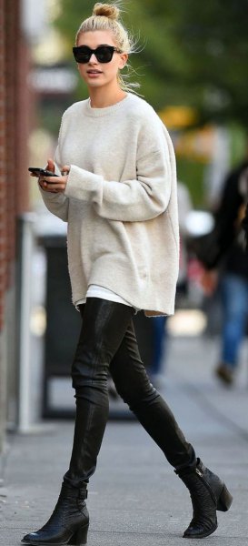white chunky sweater with crew neck with black leather pants
