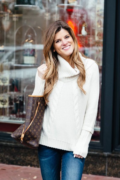 white knit sweater with blue slim fit jeans
