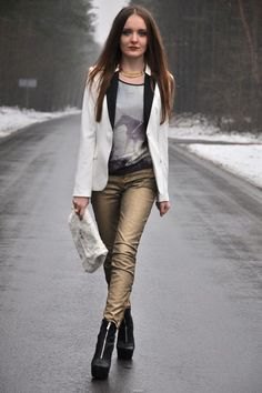 white blazer with gray scoophal printed tee and golden trousers