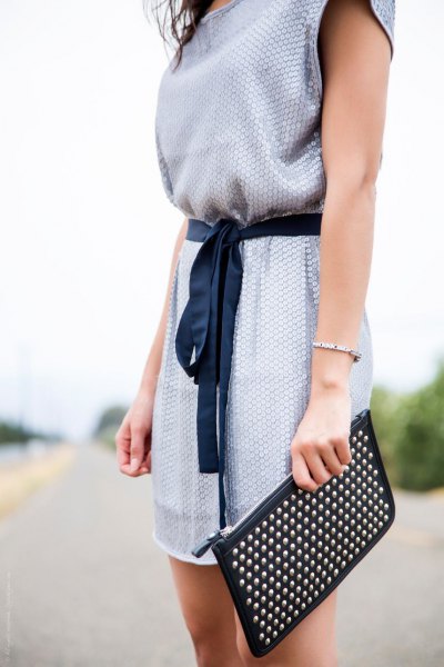 light blue belt sleeveless summer communication dress with black clutch bag