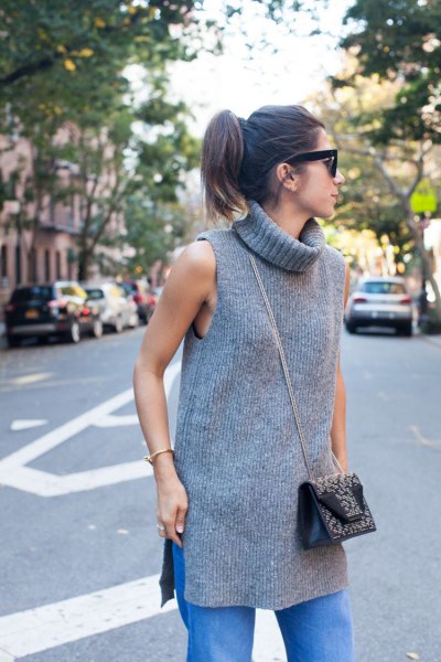 gray turtleneck sleeveless ribbed tunic with blue straight jeans