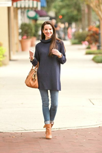 navy blue long sleeve turtleneck Tunic with cuffed jeans and orange boots