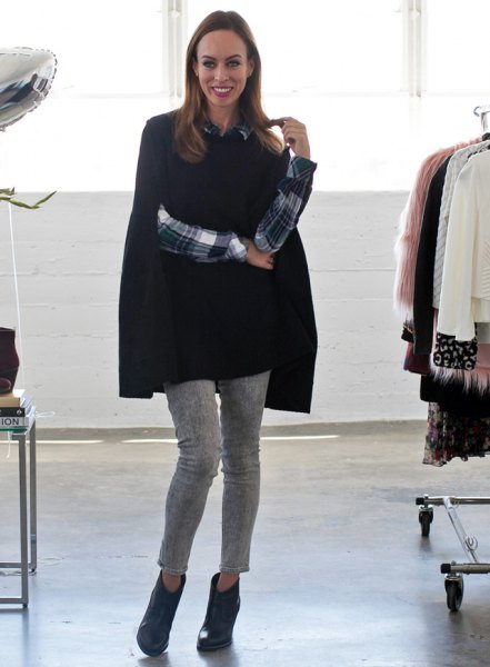 black cape sweater with plaid shirt and gray cropped pants