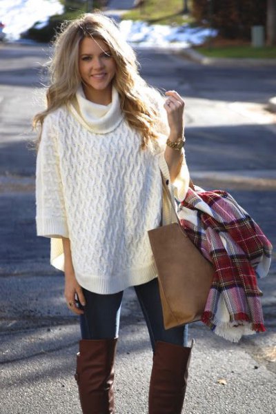 white turtleneck half-heated poncho sweater with black skinny jeans
