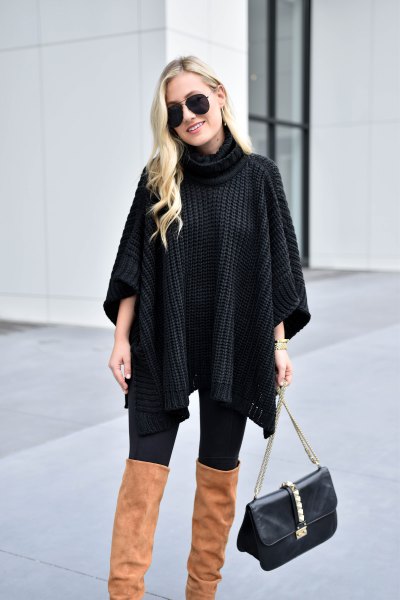 black turtleneck cable knit poncho sweater with camel thigh high boots