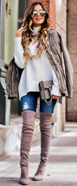white chunky sweater with light gray oversized leather jacket and high suede boots in the thigh