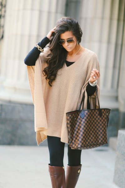 ivory with ribbed cape sweater with black leggings and gray over knee-high boots