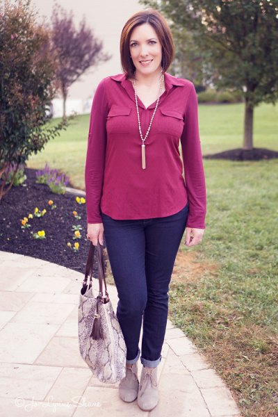pink blouse with navy blue cuffed jeans and gray suede ankle boots