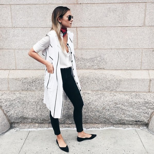 white long-line vest with long cut blouse and black pointed flats