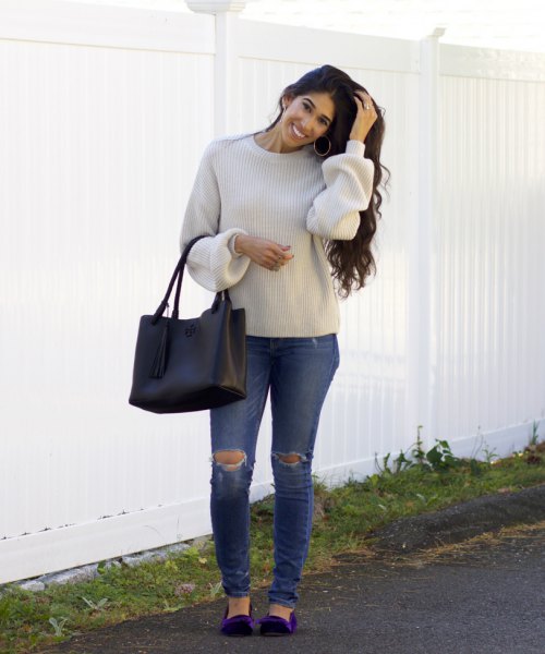 light gray sweater with crew neck with ripped jeans and navy velvet flats