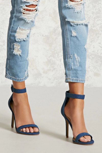 heavily ripped ankle slim fit jeans and blue ankle strap open toe denim heels