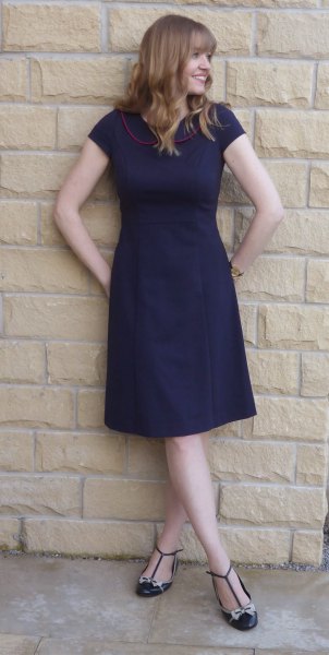 navy blue short-sleeved fit and floral knee-length dress with striped flats