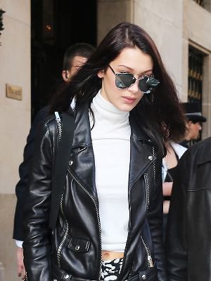 white cropped sweater with mock neck with black motorcycle jacket