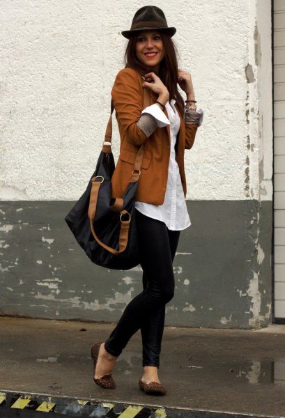 brown blazer with white oversized button up shirt and black floppy hat
