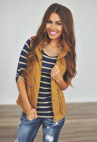 lime green hooded vest with navy and pink striped tee and ripped jeans