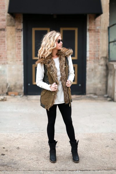 white sweater with crew neck with faux fur olive green military vest