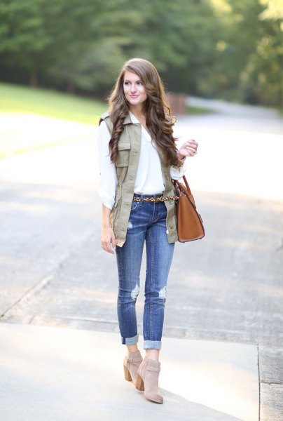 white blouse with light brown vest and gray suede suede boots
