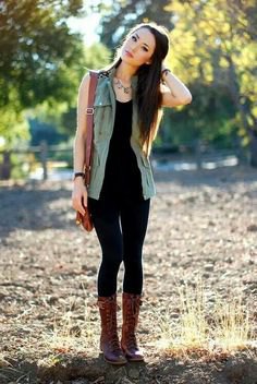 black tank top with matching slim jeans and lace-up boots in the middle of the calf