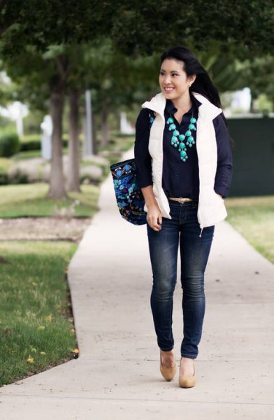 white puffer vest with back-up shirt and dark blue skinny jeans
