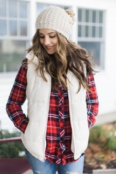 white knitted hat with red and black checkered shirt and light blue jeans