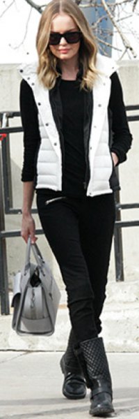 white hood down vest with black sweater and jeans
