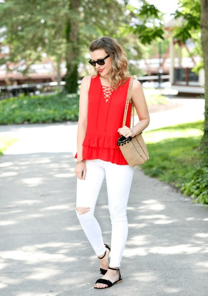 red criss cross front v-neck sleeveless blouse with white ripped jeans