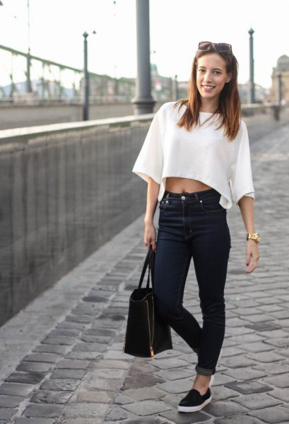 white short-sleeved cropped top with cuffed jeans and canvas loafers