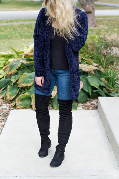 navy blue ribbed cardigan with skinny jeans and high thigh boots