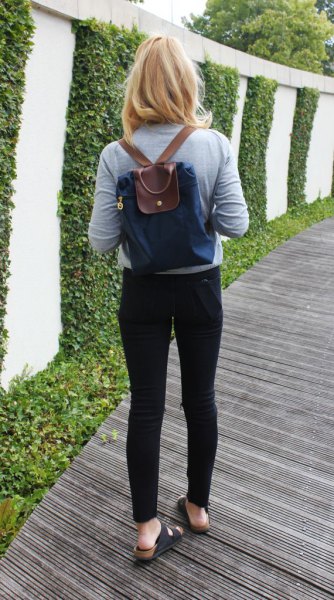 navy and brown backpack bag with gray long sleeve tee