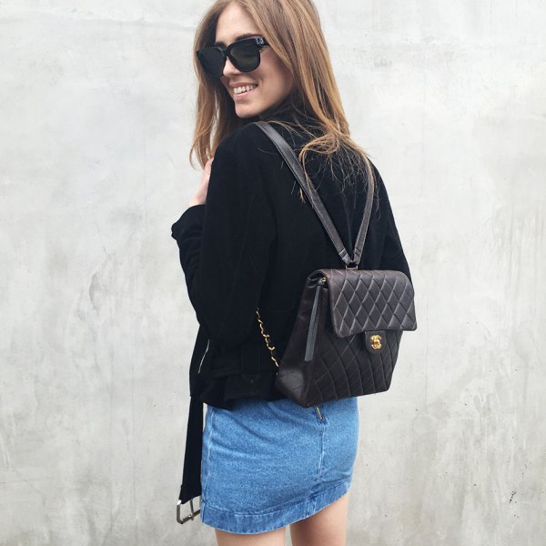 black quilted leather backpack with velvet jacket and denim mini skirt