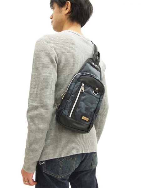 light gray ribbed sweater with camo bag
