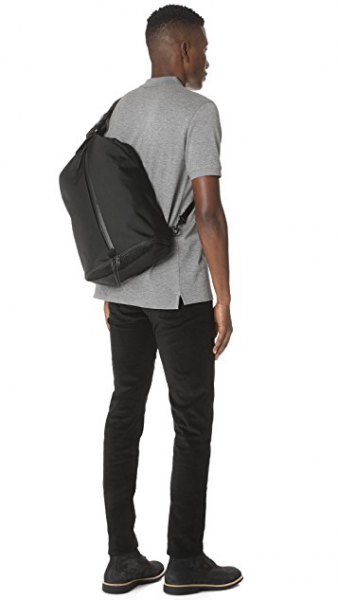 gray polo shirt with black skinny jeans and lift bag