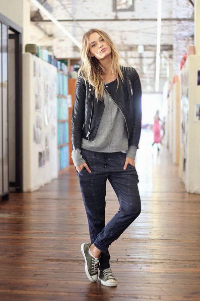 black leather jacket with gray sweater and dark blue jogging jeans