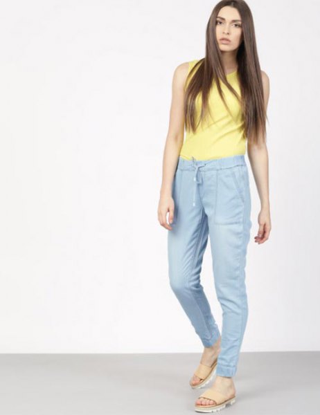 yellow sleeveless top with blue waist with high waist jogging pants