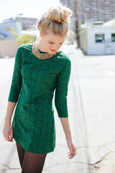 three-quarter sleeve dark green lace mini dress with gold necklace