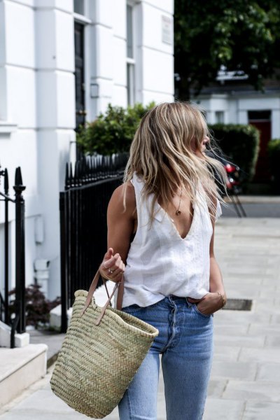 white v-shirt with blue jeans and straw bag