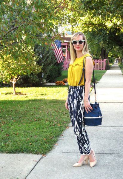 mustard yellow sleeveless top with black and white printed casual fit pants