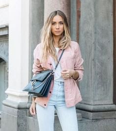 pink jacket with white tee and light blue mom jeans