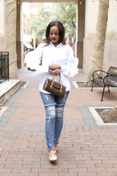 white ruffle sleeve button up shirt with ripped slim cut jeans