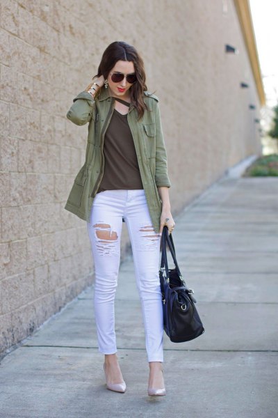 casual olive jacket with green top on the v-neck and white skinny jeans