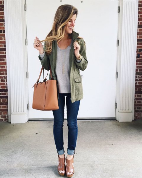 olive jacket with gray sweater and cuffed dark blue skinny jeans